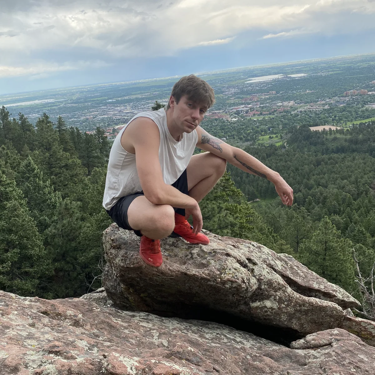 Squatting on mountain overlook