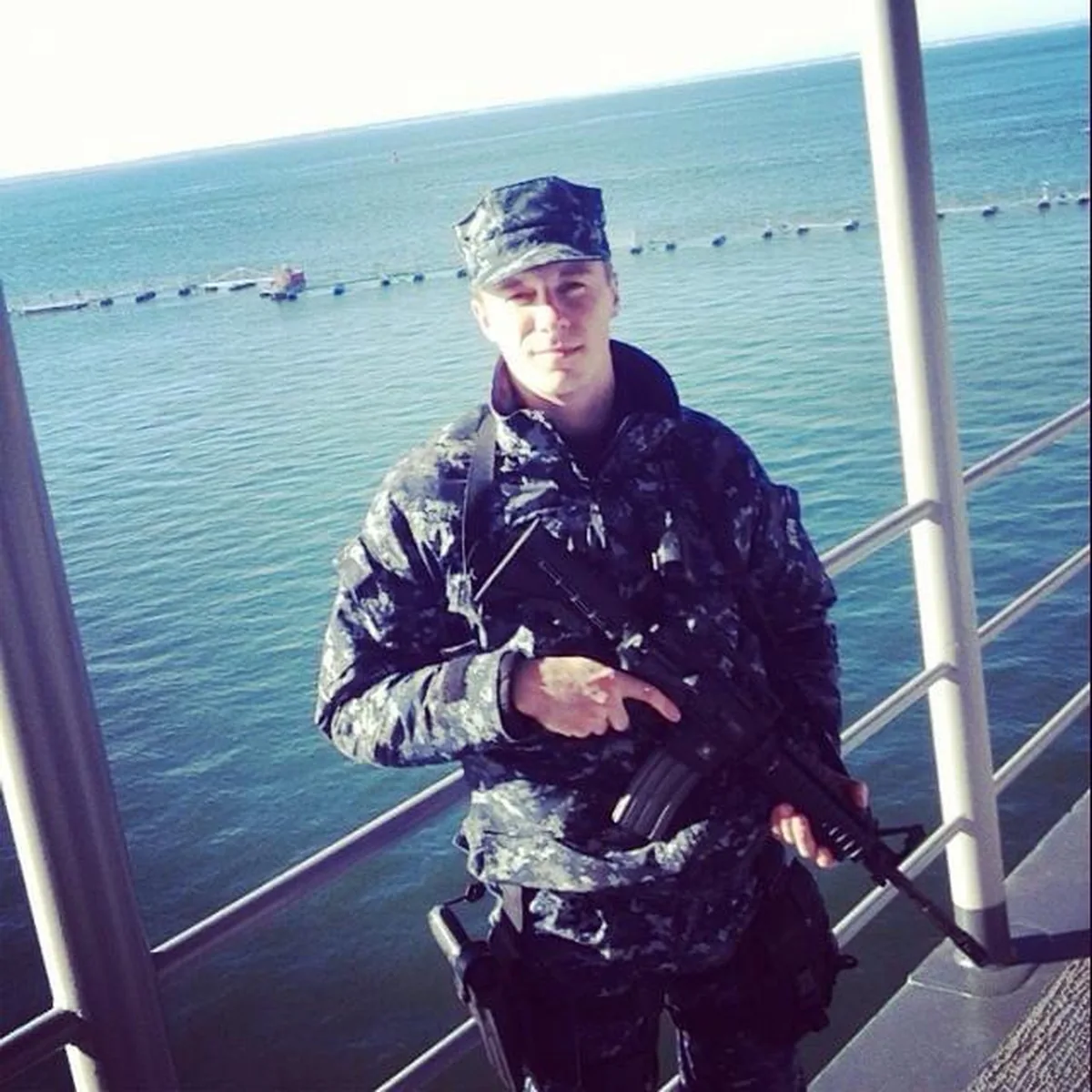 Chase in Navy NWU on ship deck with rifle